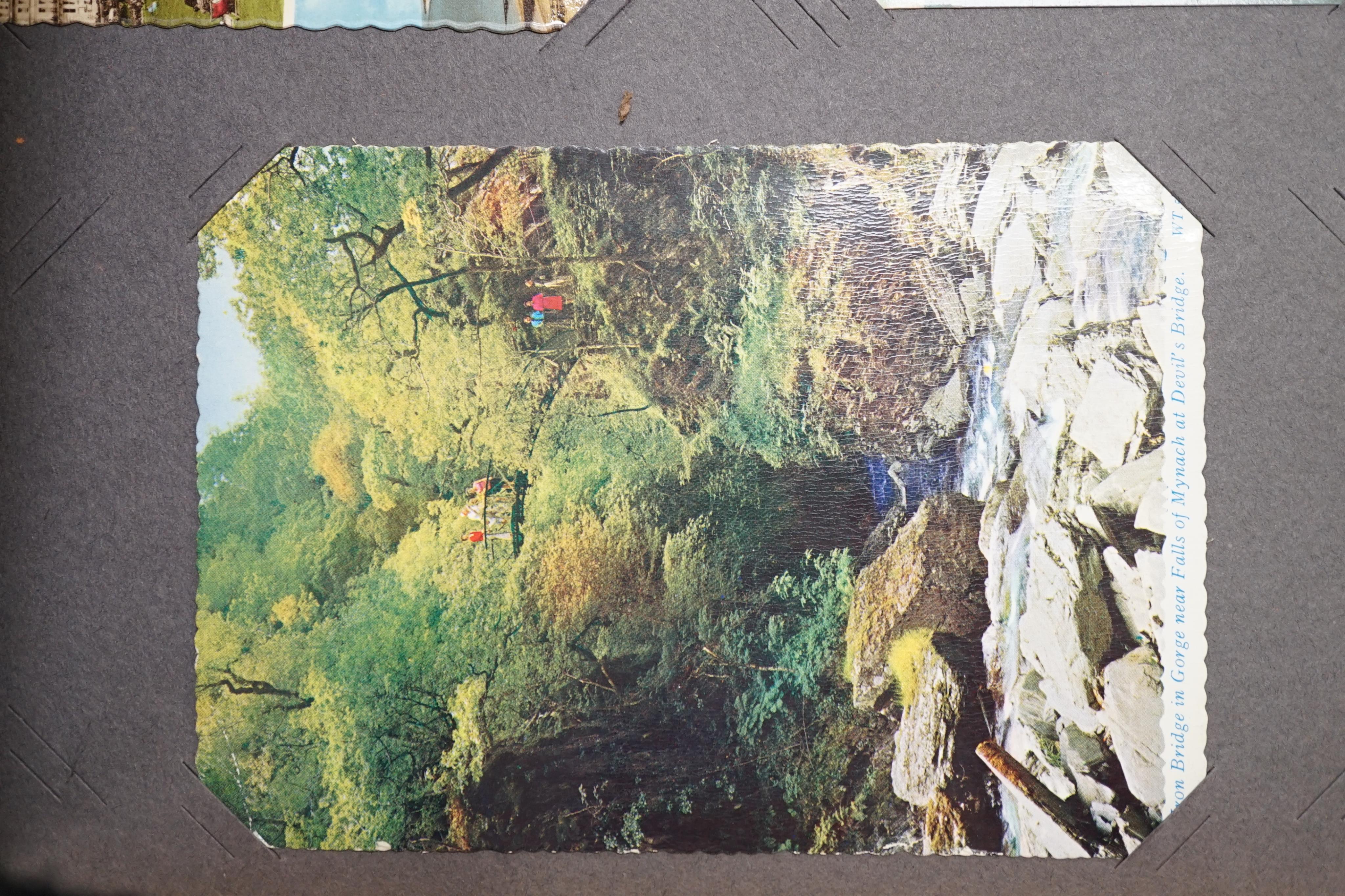 A collection of miscellaneous postcards in albums and an empty Victorian photograph album. Condition - poor to fair
